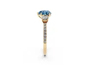 Fancy Blue Heart Cut Diamond Three-Stone Ring Set in Yellow gold with Pavé Band and Graduated Sides