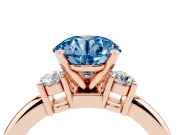Fancy Blue Three-Stone Round Cut Diamond Ring Set in Rose gold with Prong Setting and Plain Band