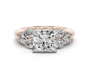Princess Cut Diamond Cluster Ring Set in Rose gold with Round Accent Stones and Prong Setting on a Plain Band
