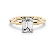 Emerald Cut Diamond Solitaire Ring Set in Yellow gold with Prong Setting on a Polished Plain Band