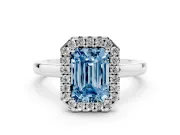Fancy Blue Emerald Cut Diamond Halo Solitaire Ring Set in Silver with Pavé Band and Prong Setting