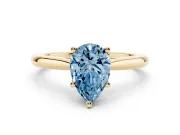 Fancy Blue Pear Cut Diamond Solitaire Ring Set in Yellow gold with Cathedral Band and Prong Setting