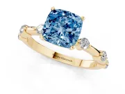 Fancy Blue Cushion Cut Diamond Solitaire Ring Set in Yellow gold with Bezel Set Side Stones and Prong Setting