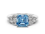 Fancy Blue Asscher Cut Diamond Cluster Ring Set in White gold with Round Accent Stones and Prong Setting on a Plain Band