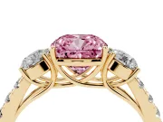 Fancy Pink Cushion Cut Diamond Three-Stone Ring Set in Yellow gold with Round Side Stones and Delicate Pavé Band
