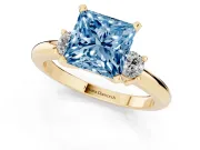 Fancy Blue Three-Stone Princess Cut Diamond Ring Set in Yellow gold with Prong Setting and Plain Band