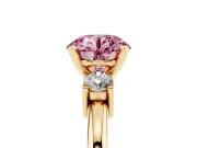 Fancy Pink Three-Stone Round Cut Diamond Ring Set in Yellow gold with Prong Setting and Plain Band