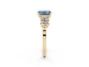 Fancy Blue Emerald Cut Diamond Cluster Engagement Ring Set in Yellow gold with Pavé Band and Prong Setting