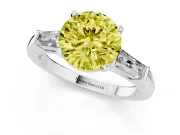 Fancy Yellow Round Cut Diamond Solitaire Ring Set in White gold with Tapered Baguette Side Stones and Prong Setting