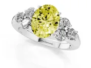 Fancy Yellow Oval Cut Diamond Cluster Ring Set in Silver with Round Accent Stones and Prong Setting on a Plain Band