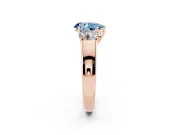 Fancy Blue Three-Stone Pear Cut Diamond Ring Set in Rose gold with Matching Prong Settings and Plain Band