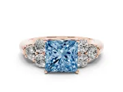 Fancy Blue Princess Cut Diamond Cluster Ring Set in Rose gold with Round Accent Stones and Prong Setting on a Plain Band