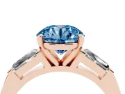 Fancy Blue Round Cut Diamond Solitaire Ring Set in Rose gold with Tapered Baguette Side Stones and Prong Setting