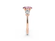 Fancy Pink Three-Stone Oval Cut Diamond Ring Set in Rose gold with Pear Side Stones and Prong Setting