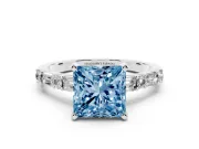 Fancy Blue Princess Cut Diamond Solitaire Set in Platinum with Side Baguettes and Channel Set Band