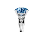 Fancy Blue Three-Stone Round Cut Diamond Ring Set in Platinum with Prong Setting and Plain Band
