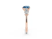 Fancy Blue Three-Stone Heart Cut Diamond Ring Set in Rose gold with Pear Side Stones and Prong Setting