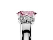 Fancy Pink Three-Stone Oval Cut Diamond Ring Set in Platinum with Matching Prong Settings and Plain Band