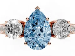 Fancy Blue Pear Cut Diamond Three-Stone Ring Set in Rose gold with Round Side Stones and Pavé Band