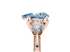Fancy Blue Pear Cut Diamond Three-Stone Ring Set in Rose gold with Pavé Band and Smaller Side Stones