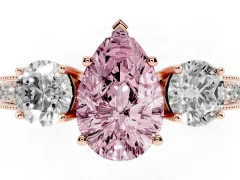 Fancy Pink Pear Cut Diamond Three-Stone Ring Set in Rose gold with Round Side Stones and Pavé Band