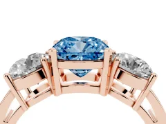 Fancy Blue Cushion Cut Diamond Three-Stone Ring Set in Rose gold with Round Side Stones and Classic Band