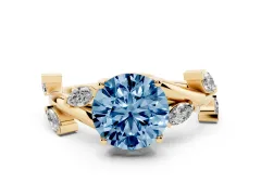 Fancy Blue Round Cut Diamond Solitaire Ring Set in Yellow gold with Twisted Marquise Accent Band