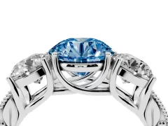 Fancy Blue Round Cut Diamond Three-Stone Engagement Ring Set in Platinum with Milgrain Pavé Band