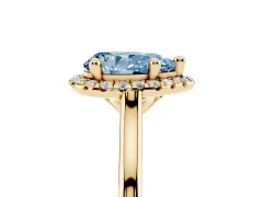 Fancy Blue Pear Cut Diamond Halo Engagement Ring Set in Yellow gold with Pavé Band and Rising Shoulders