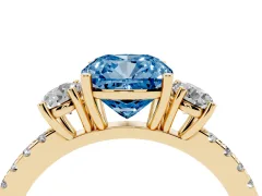 Fancy Blue Cushion Cut Diamond Three-Stone Ring Set in Yellow gold with Pavé Band and Graduated Sides