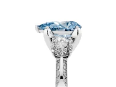Fancy Blue Pear Cut Diamond Three-Stone Ring Set in Platinum with Pavé Band and Smaller Side Stones