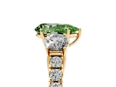 Fancy Green Pear Cut Diamond Three-Stone Ring Set in Yellow gold with Round Side Stones and Delicate Pavé Band