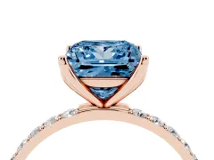 Fancy Blue Princess Cut Diamond Solitaire Engagement Ring Set in Rose gold with Round Pavé Band and Prong Setting