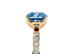 Fancy Blue Cushion Cut Diamond Solitaire Engagement Ring Set in Yellow gold with Round Pavé Band and Prong Setting