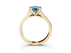 Fancy Blue Emerald Cut Diamond Bezel-Set Solitaire Ring Set in Yellow gold with Channel-Set Band