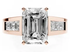 Emerald Cut Diamond Solitaire Ring Set in Rose gold with Channel-Set Accent Stones and Prong Setting