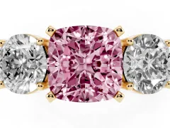 Fancy Pink Cushion Cut Diamond Three-Stone Ring Set in Yellow gold with Round Side Stones and Classic Band