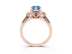Fancy Blue Cushion Cut Diamond Three-Stone Ring Set in Rose gold with Pavé Band and Smaller Side Stones