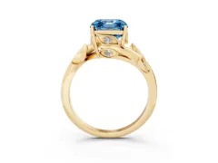 Fancy Blue Asscher Cut Diamond Solitaire Twist Engagement Ring Set in Yellow gold with Pavé Leaf Accents