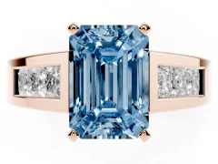 Fancy Blue Emerald Cut Diamond Solitaire Ring Set in Rose gold with Channel-Set Accent Stones and Prong Setting