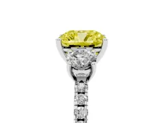 Fancy Yellow Cushion Cut Diamond Three-Stone Ring Set in White gold with Pavé Band and Graduated Sides
