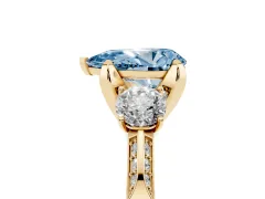 Fancy Blue Pear Cut Diamond Three-Stone Ring Set in Yellow gold with Pavé Band and Smaller Side Stones