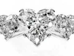 Heart Cut Diamond Three-Stone Ring Set in Platinum with Channel-Set Band and Prong Settings