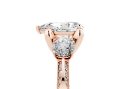 Pear Cut Diamond Three-Stone Ring Set in Rose gold with Pavé Band and Smaller Side Stones