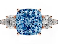 Fancy Blue Cushion Cut Diamond Three-Stone Ring Set in Rose gold with Pavé Band and Graduated Sides
