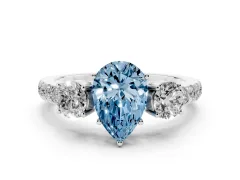 Fancy Blue Pear Cut Diamond Three-Stone Ring Set in Silver with Round Side Stones and Delicate Pavé Band