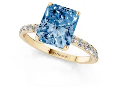 Fancy Blue Radiant Cut Diamond Solitaire Engagement Ring Set in Yellow gold with Round Pavé Band and Prong Setting