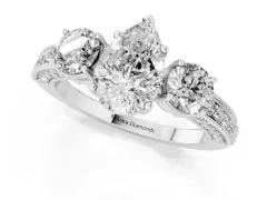 Pear Cut Diamond Three-Stone Ring Set in Platinum with Round Side Stones and Pavé Band
