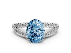 Fancy Blue Oval Cut Diamond Split Shank Pavé Engagement Ring Set in White gold with Prong-Held Center Stone