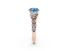 Fancy Blue Round Cut Diamond Three-Stone Ring Set in Rose gold with Pavé Band